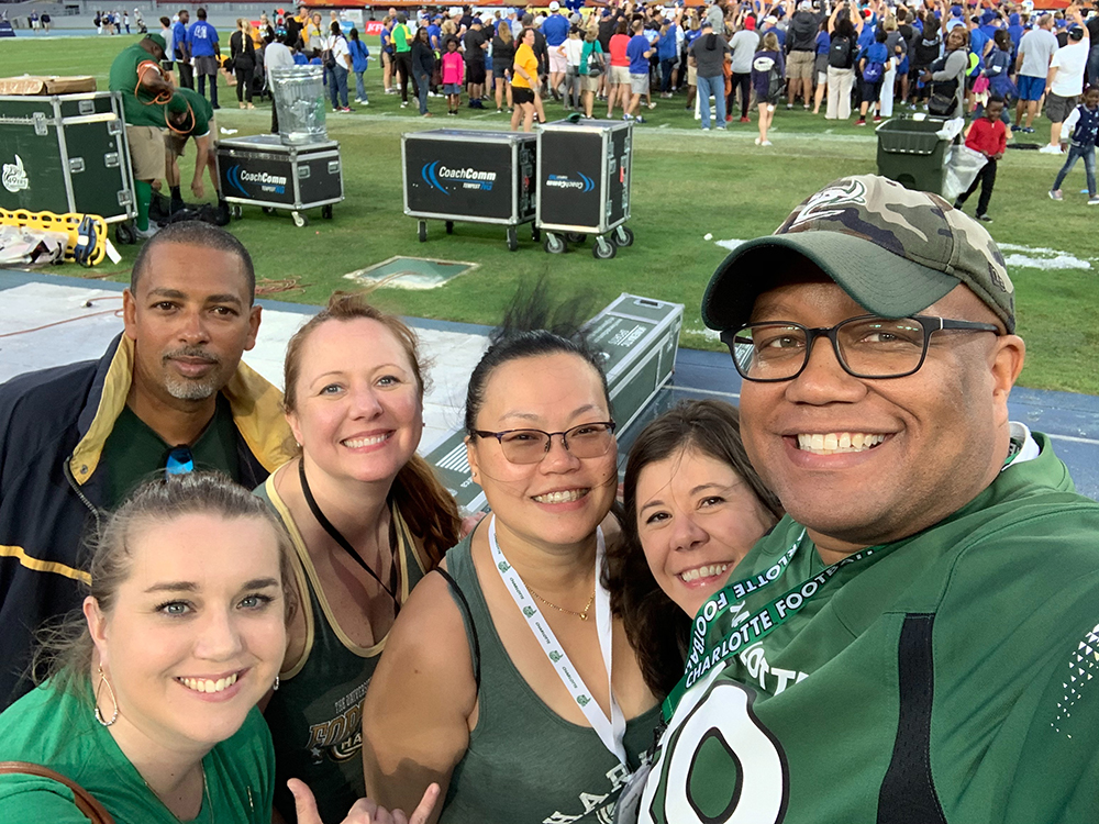 Rodney Graves ‘97, Robert Garraway ‘96 and 49er fans on the sidelines after the Bahamas Bowl